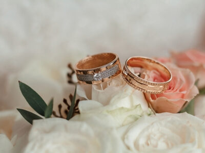 wedding rings close up on bouquet rose.